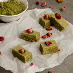 Green matcha caramels wrapped in clear paper, with a 1kg Matcha Maiden Organic Matcha Powder pouch in the background.