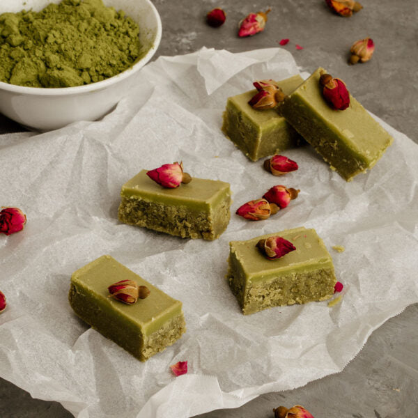 Green matcha caramels wrapped in clear paper, with a 1kg Matcha Maiden Organic Matcha Powder pouch in the background.