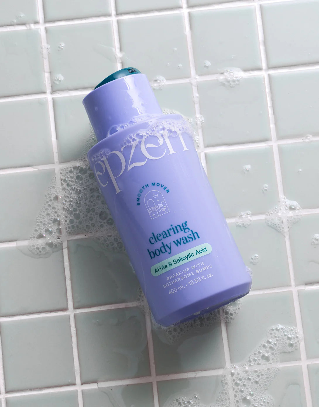 Model of an Epzen Clearing Body Wash bottle against a blue and white background with abstract shapes.