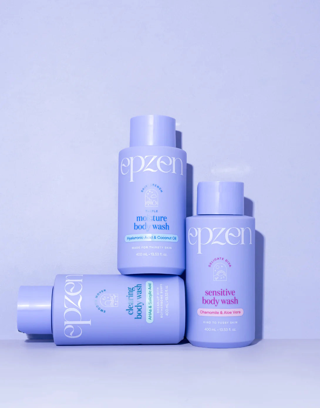 Epzen Sensitive Body Wash 400ml bottle shown with fresh chamomile flowers and sliced aloe vera leaves.