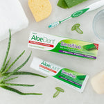 Top view of the box and 100ml tube of Aloe Dent Sensitive toothpaste with green and white packaging.