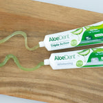 Infographic showing a 100ml Aloe Dent Triple Action toothpaste tube with key ingredients and their benefits.