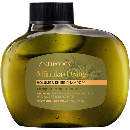 Antipodes Manuka + Orange Volume & Shine Shampoo 340ml bottle with a white pump and botanical label illustrations.