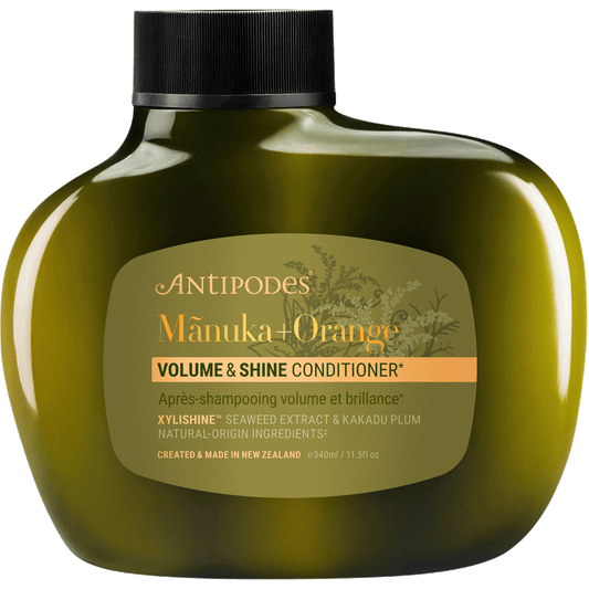 340ml bottle of Antipodes Manuka + Orange Volume & Shine Conditioner featuring orange and floral illustrations.