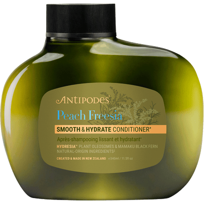 Antipodes Peach Freesia Smooth and Hydrate Conditioner in a 340ml white pump bottle on a white background.