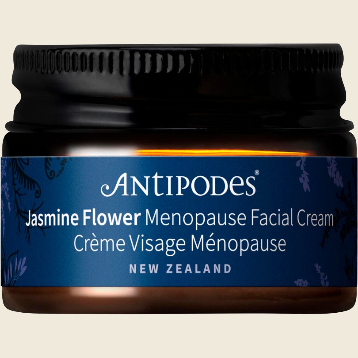 15ml mini glass jar of Antipodes Jasmine Flower Menopause Facial Cream with a silver lid.