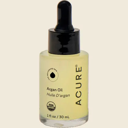 ACURE The Essentials Argan Oil 30ml glass bottle with a yellow and white geometric label on a white background.