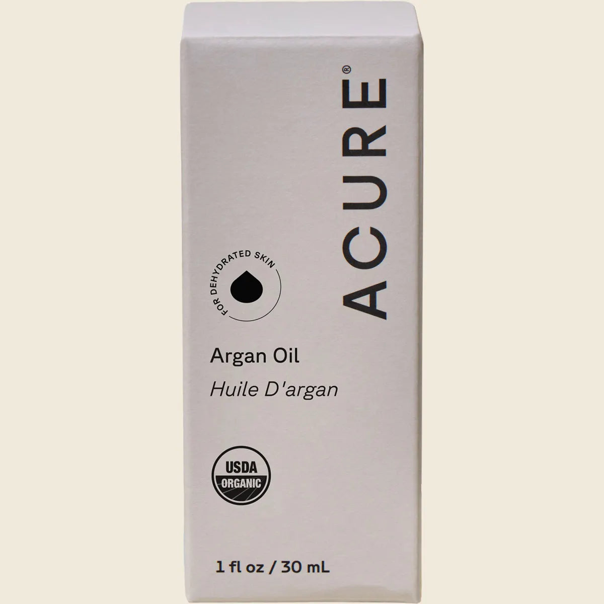 ACURE The Essentials Argan Oil 30ml packaging box with a yellow and white geometric design on a white background.