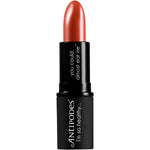 Antipodes Boom Rock Bronze Lipstick in a sleek black tube, showcasing a warm medium brown shade on a white background.