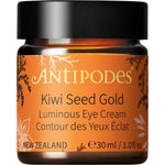 Open glass jar of Antipodes Kiwi Seed Gold Luminous Eye Cream showing its creamy texture with 23K gold flakes.