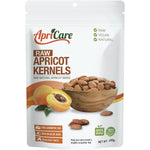 500g bag of Apricare Raw Apricot Kernels, certified organic and unprocessed, on a white background.