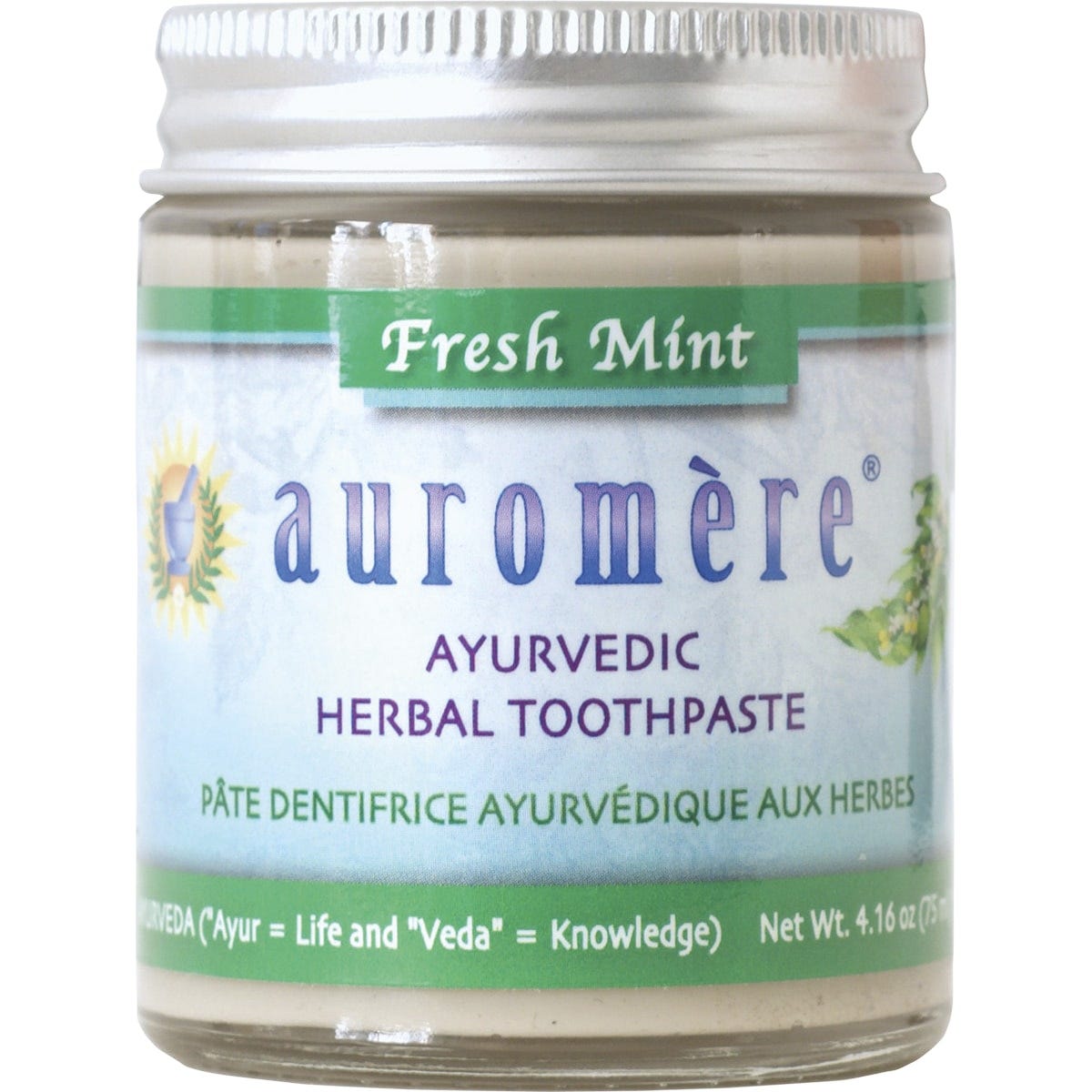 Auromere Fresh Mint Ayurvedic toothpaste in a glass jar with a metal lid and a small wooden spoon on a white background.