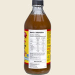 Right-angle view of a 473ml bottle of Bragg Pineapple Turmeric Apple Cider Vinegar Blend on a white background.