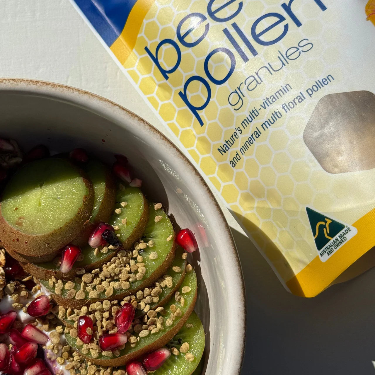 Close-up of multi-colored Natural Life Bee Pollen Granules showing their natural texture and variety.