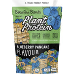 1kg tub of Botanika Blends Blueberry Pancake plant protein with a blue label featuring blueberry illustrations.