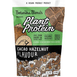 1kg tub of Botanika Blends Plant Protein Cacao Hazelnut featuring a dark label and botanical illustrations.