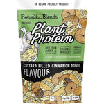 1kg tub of Botanika Blends Cinnamon Donut plant protein with donut and botanical illustrations on a brown label.