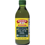 473ml glass bottle of Bragg unrefined Organic Extra Virgin Olive Oil with a yellow and red label on a white background.