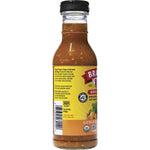 Bragg Ginger and Sesame 354ml glass bottle of organic salad dressing and marinade on a white background.