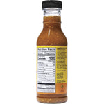 354ml glass bottle of Bragg organic Ginger and Sesame dressing and marinade on a white background.