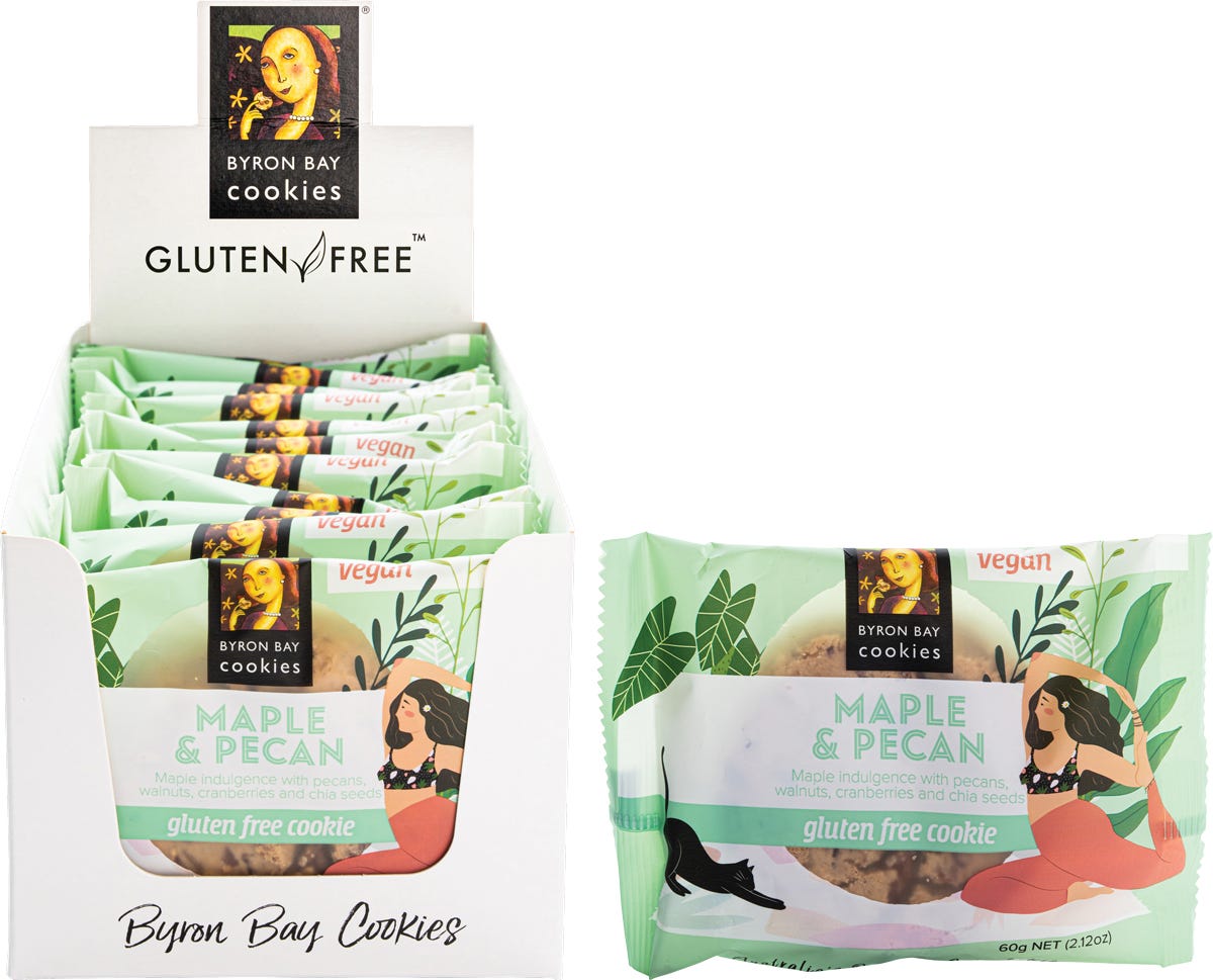 Byron Bay Gluten Free Maple & Pecan cookies in a blue and gold box with artistic floral and yoga illustrations.