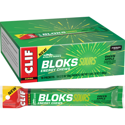 A green packet and a single sleeve of CLIF Bloks Sour Green Apple energy chews showing six individual cubes.