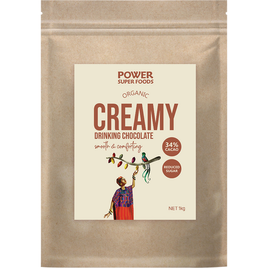 1kg bag of Power Super Foods Creamy Drinking Chocolate with a blue label and organic cacao illustrations.