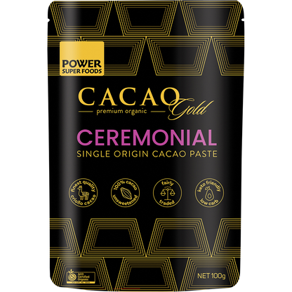 Black pouch of Power Super Foods Cacao Gold Paste Chunks with gold accents and a window showing dark cacao chunks.