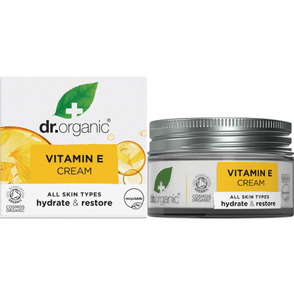 50ml jar and box of Dr Organic Vitamin E Cream featuring orange accents and botanical illustrations on a white background.