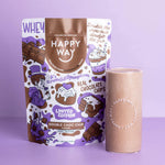 Scoop of Happy Way Double Choc Chip Protein Powder with chocolate chips and cocoa powder on a white background.
