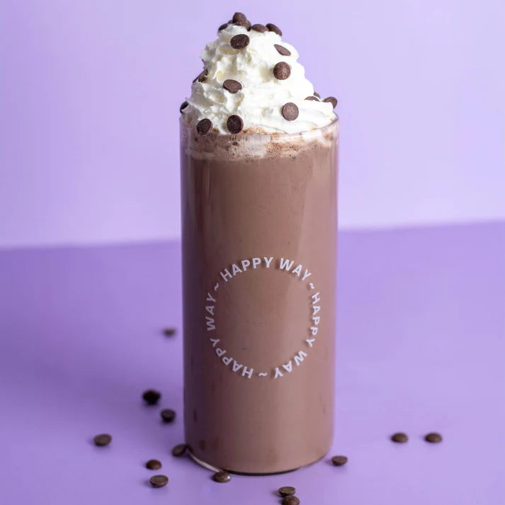 A scoop of Happy Way Double Choc Chip Whey Protein Powder with chocolate chips and cocoa powder on a white background.