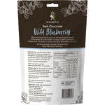 Bite-sized wild blueberries coated in smooth dark chocolate scattered on a white background.