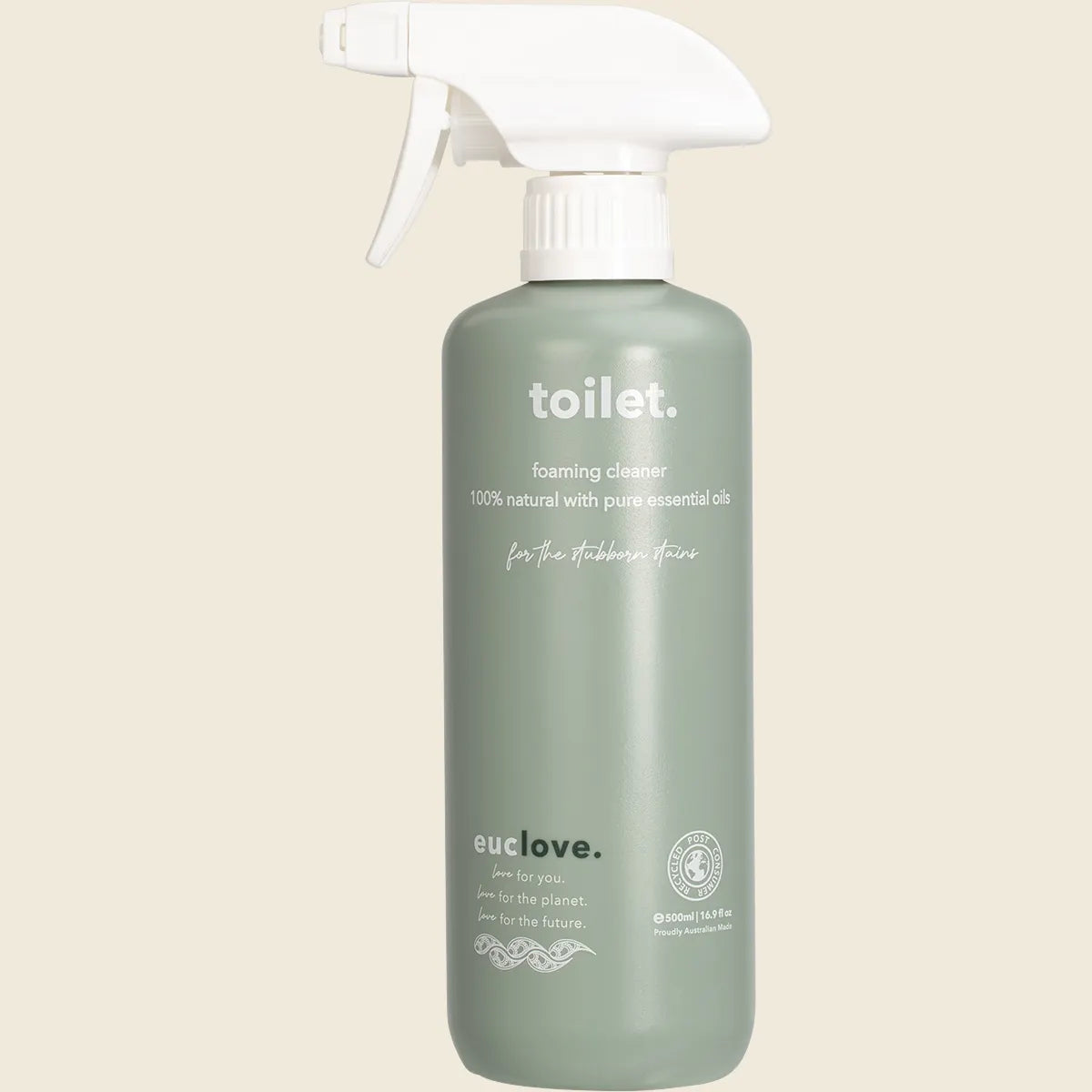 Green bottle of toilet foaming cleaner with white spray nozzle on a beige background