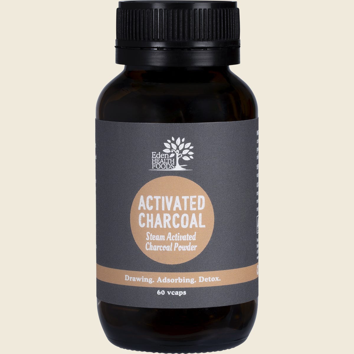 White tub of Eden Healthfoods Activated Charcoal 60 capsules with a black and white label on a clean background.