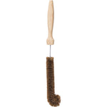 Eco-friendly bottle brush with coconut fiber bristles and a curved tip on a wooden handle.