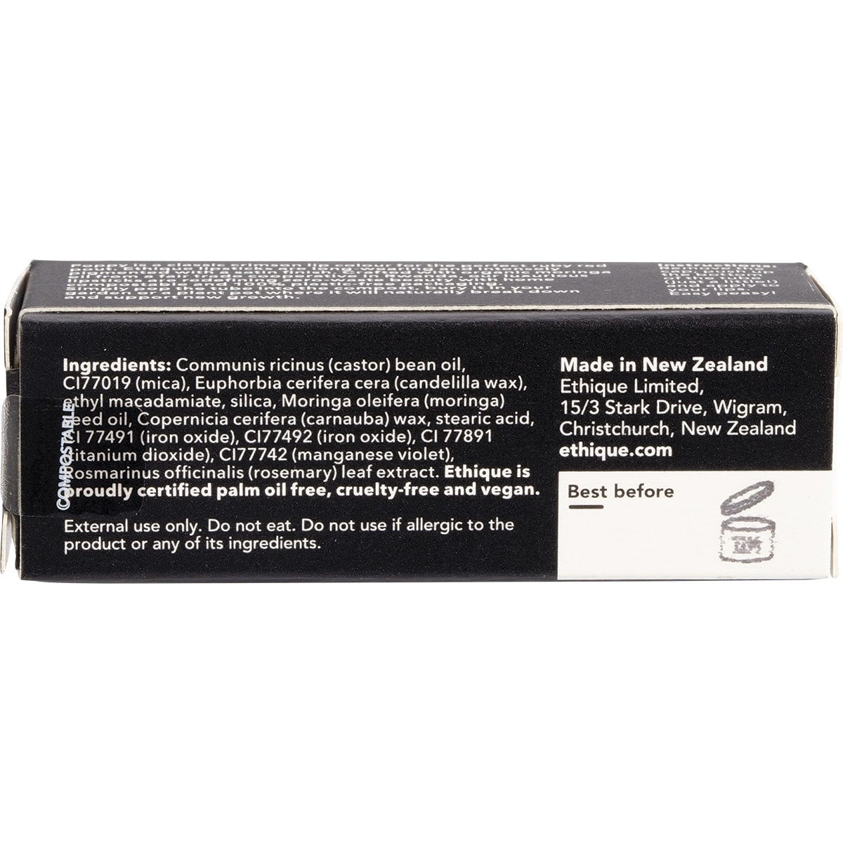 Ethique Poppy Ruby Red lipstick in a black compostable cardboard tube, shown standing on a white background.