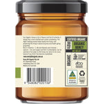 A 325g glass jar of Every Bit Organic Raw Honey with a yellow label on a white background.