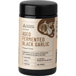 120g violet glass jar of Evolution Botanicals Aged Fermented Black Garlic extract powder with a black lid.