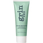 Grin Pro Enzyme Whitening with Fluoride 113g toothpaste tube featuring purple and white packaging on a white background.