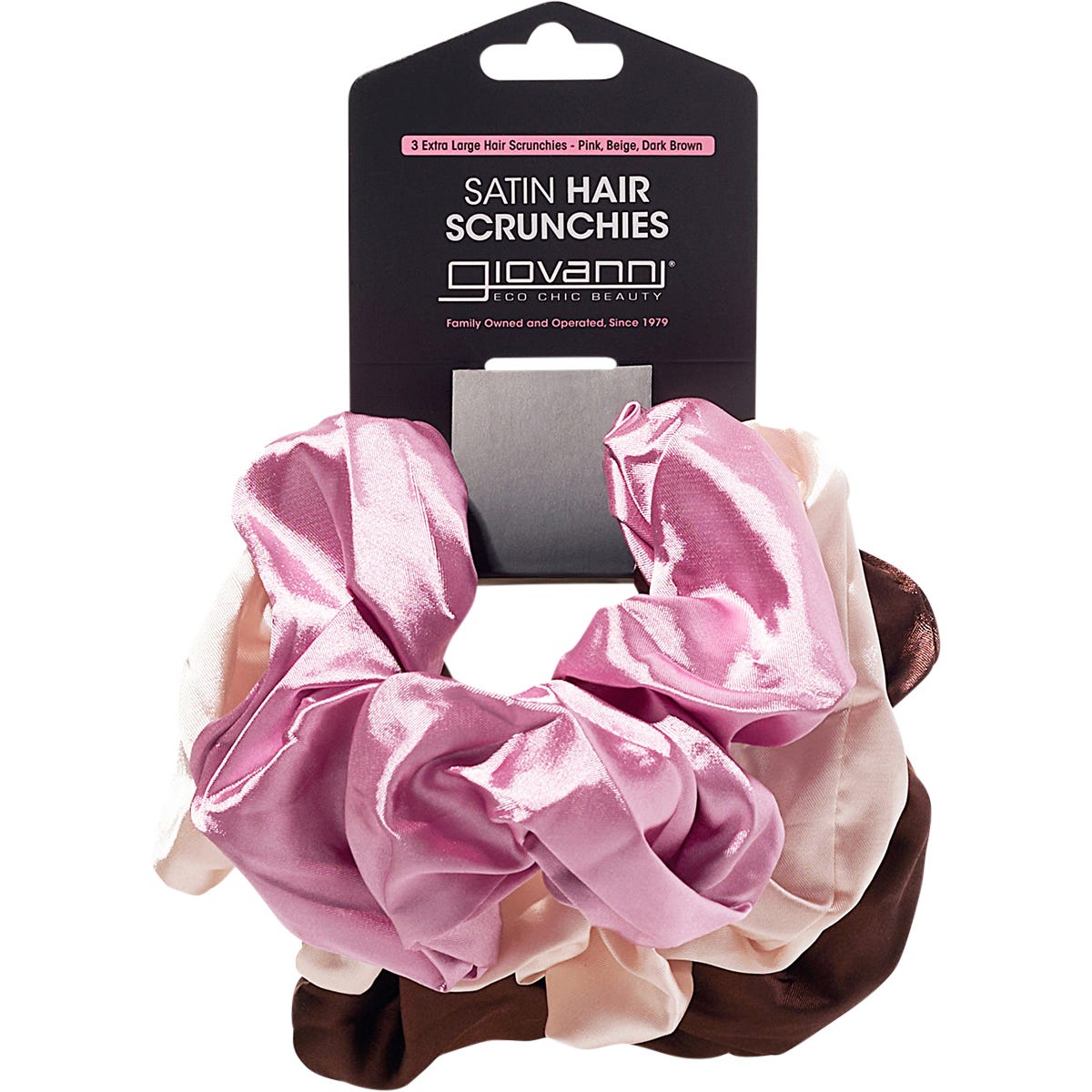 Three extra-large satin hair scrunchies in pink, beige, and dark brown from Giovanni, shown in their packaging.