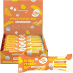 A box of Happy Way Whey Protein Bars in Mango Cream Flavour, with one bar displayed in front. The packaging is bright orange and yellow with illustrations of mango slices.