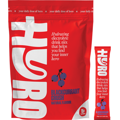 Hyro Blackcurrant Crush pack with 15 sachets, a single sachet, and a glass of purple drink with fresh berries.