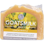 Handmade 140g bar of Harmony Soapworks Lemon Myrtle Goat's Milk Soap with crushed leaves on a white background.