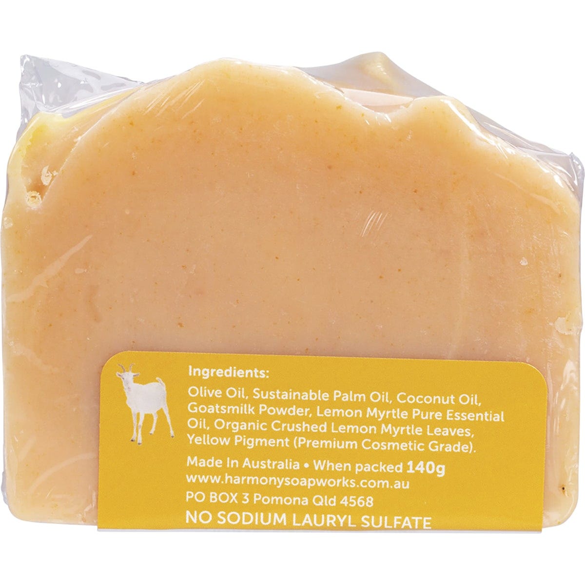 Handmade 140g bar of Harmony Soapworks Lemon Myrtle Goat's Milk Soap with crushed leaves on a white background.