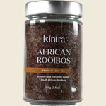 100g glass jar of Kintra Blends Loose Leaf African Rooibos tea with a red label and black lid.