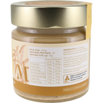 A jar of almond butter with a metallic gold lid and a cream-colored label showing nutritional facts and ingredients, photographed against a plain white background.