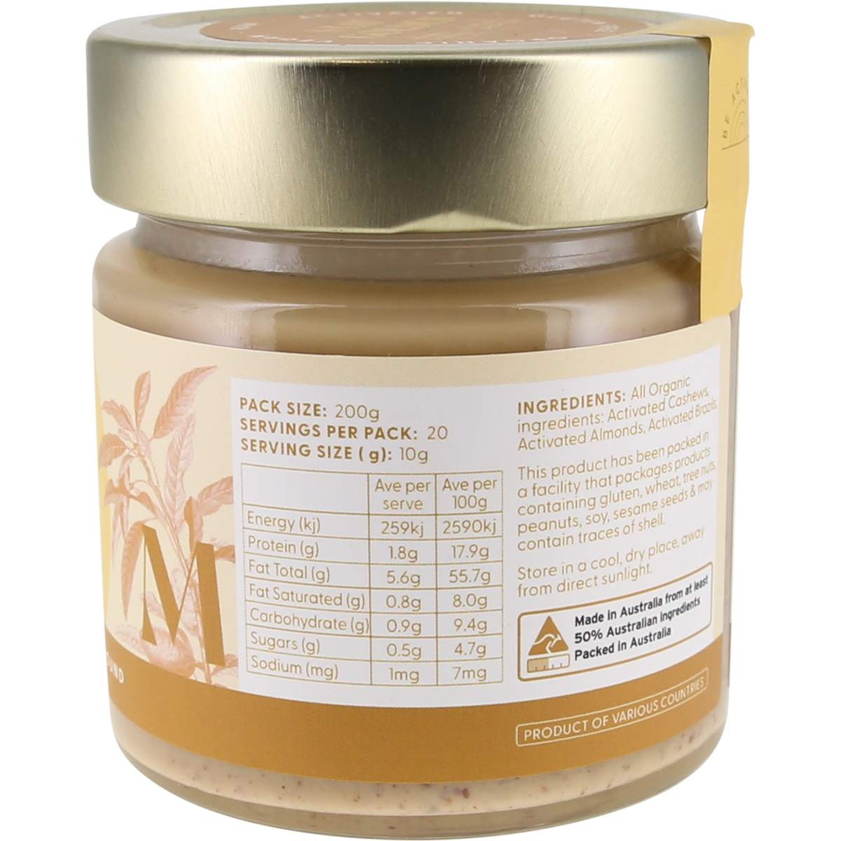 A jar of almond butter with a metallic gold lid and a cream-colored label showing nutritional facts and ingredients, photographed against a plain white background.