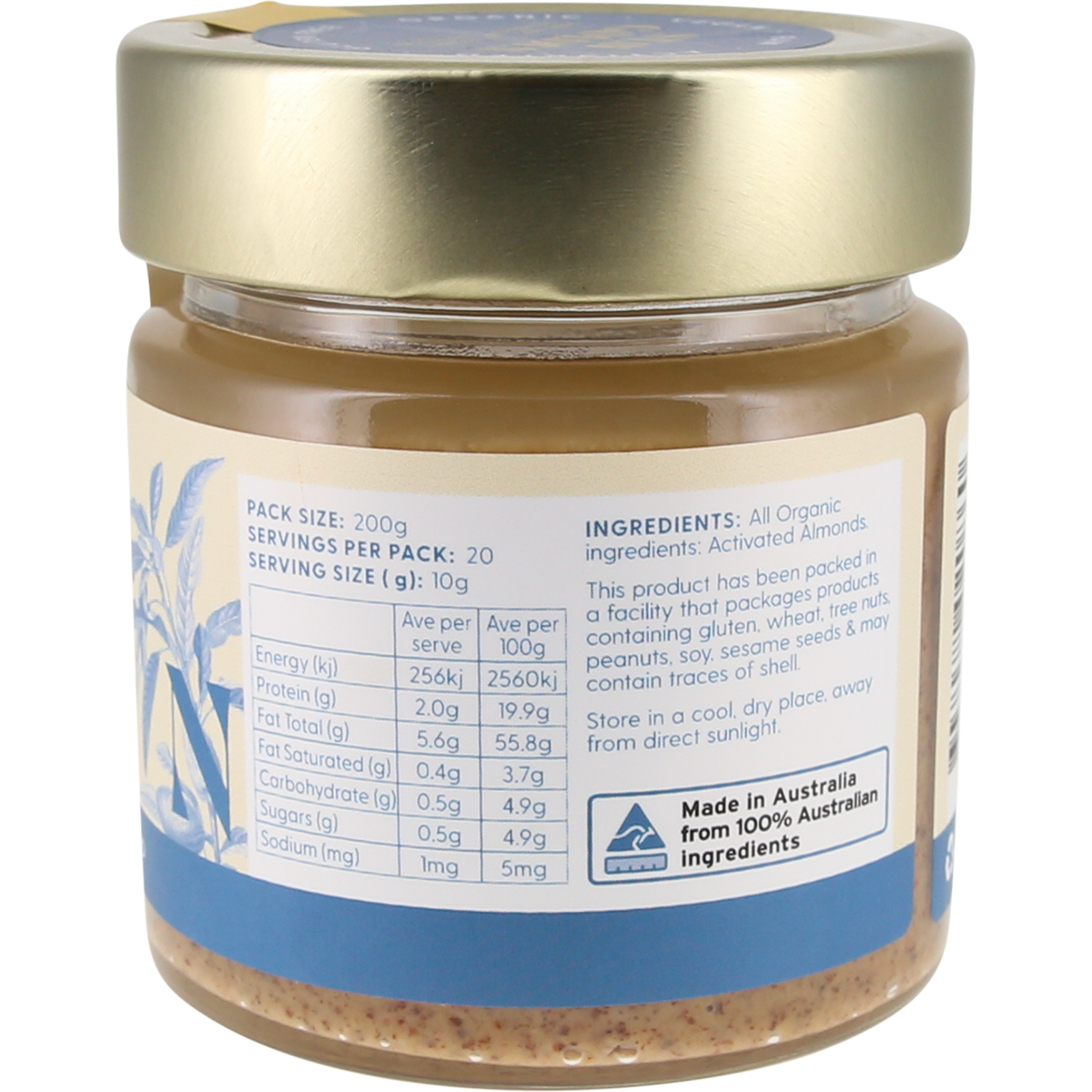 A jar of almond butter with a gold lid and a white and blue label showing nutritional information and ingredients, photographed against a white background.