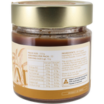 A jar of Sunrise Cocoa Powder with a gold lid and a beige label showing nutritional information and ingredients, set against a plain white background.