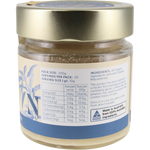 A jar of Organic Macadamia butter with a silver lid and a cream-colored label featuring blue text and illustrations, set against a plain white background.